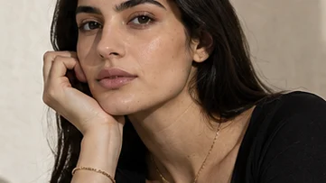 Chain bracelet worn with the hand raised to the face