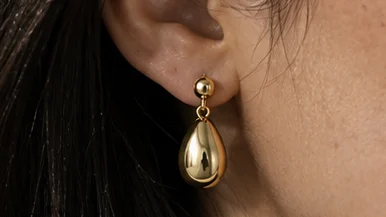 Macro close-up of the drop earring on the ear