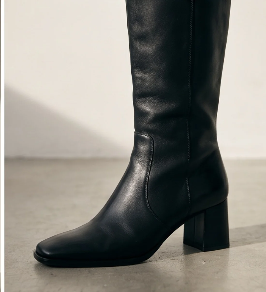 Knee-high leather boots, print and logo close-up